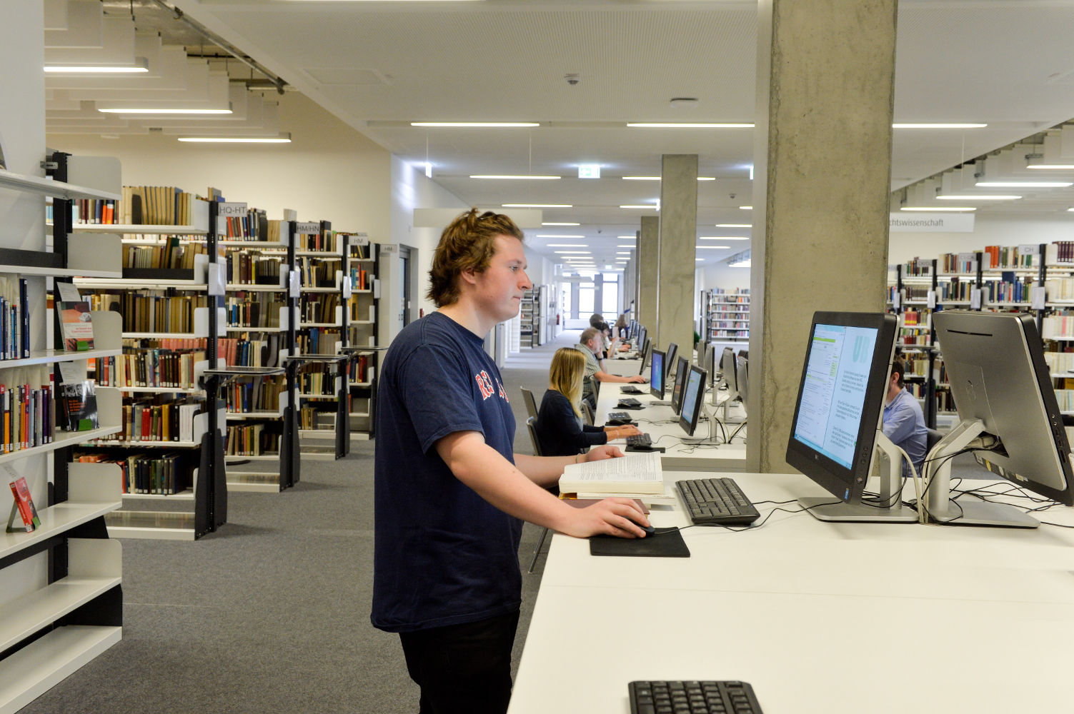 Photo of a Person at a Computer in the Library